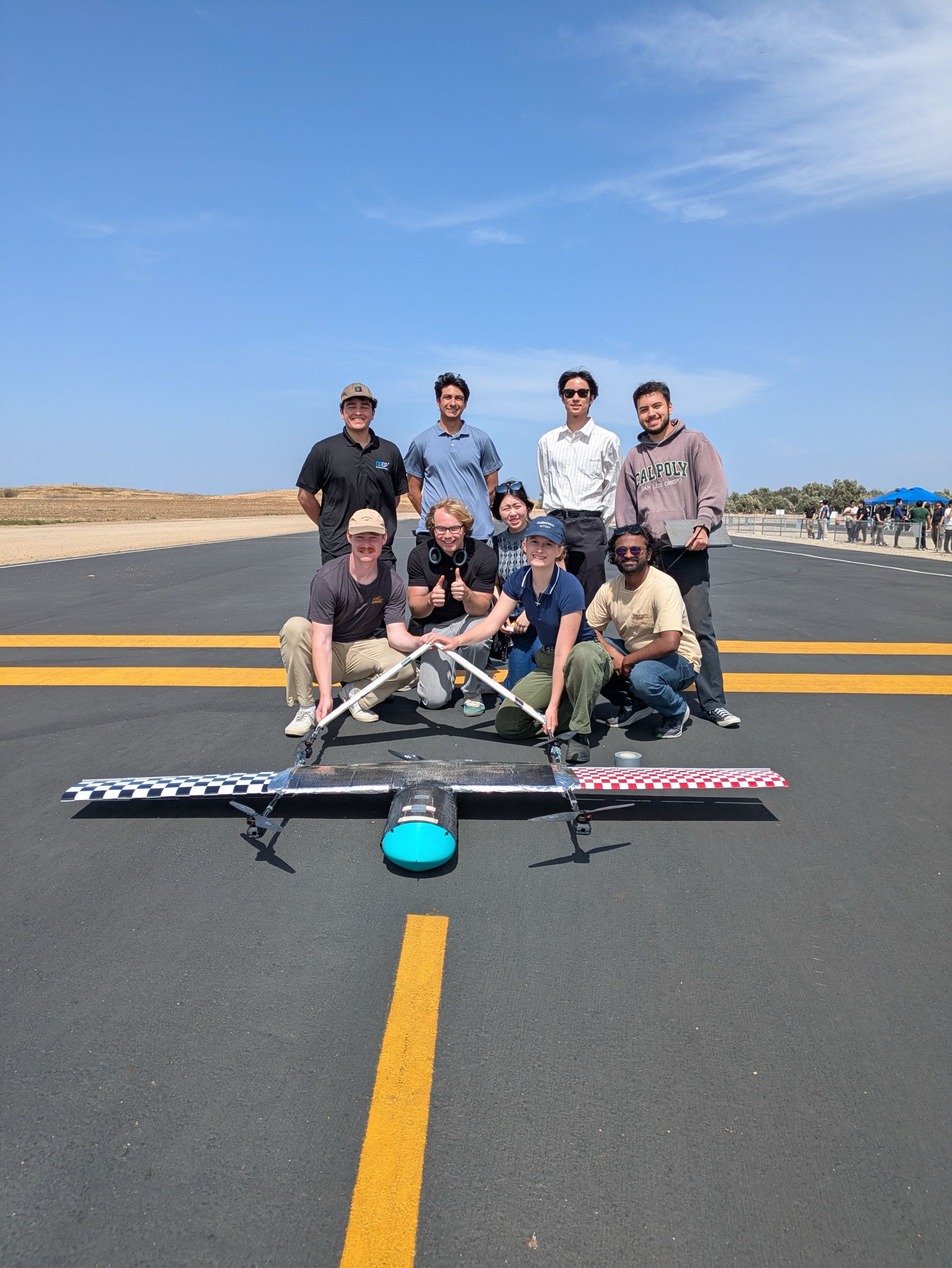 Full team with the tilt-rotor VTOL aircraft on the runway